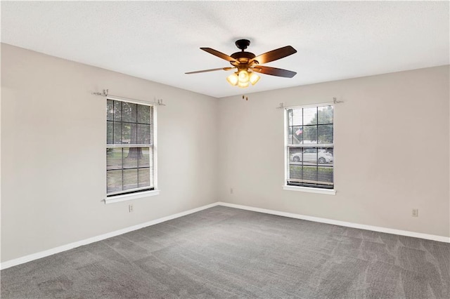 empty room with carpet, ceiling fan, a textured ceiling, and baseboards