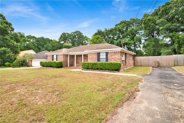 single story home featuring a garage and a front lawn