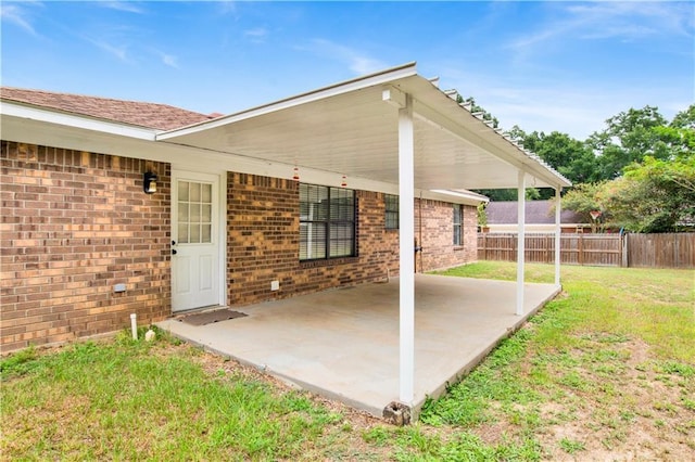 view of patio / terrace with fence and an attached carport