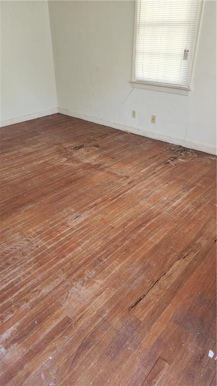 unfurnished room featuring dark hardwood / wood-style flooring