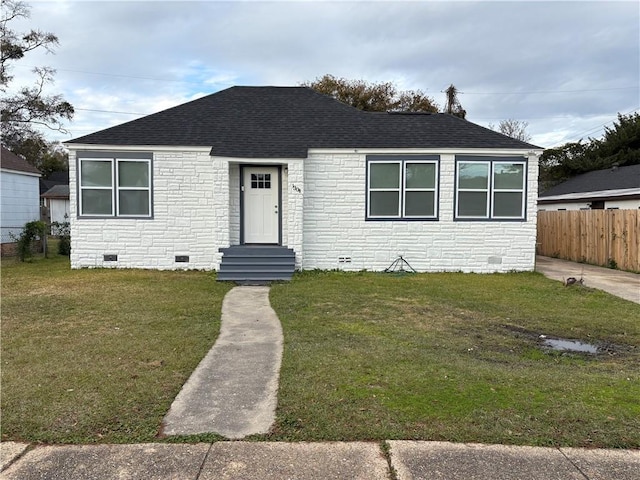 bungalow-style home with a front yard