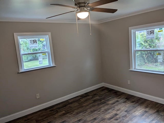 empty room featuring a healthy amount of sunlight, ceiling fan, dark hardwood / wood-style flooring, and ornamental molding