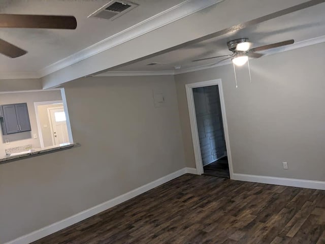 spare room featuring dark wood-type flooring and ornamental molding