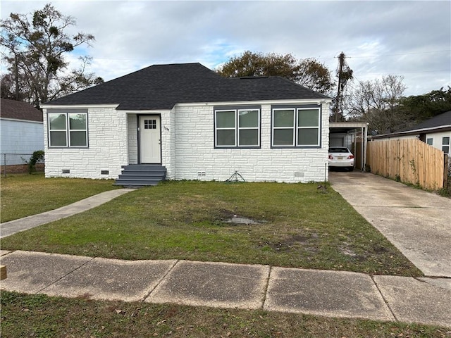 bungalow featuring a carport and a front lawn