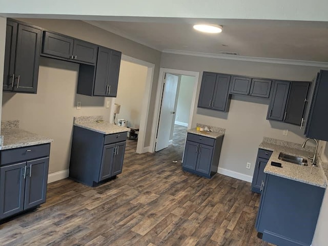 kitchen featuring light stone countertops, ornamental molding, dark hardwood / wood-style flooring, and sink