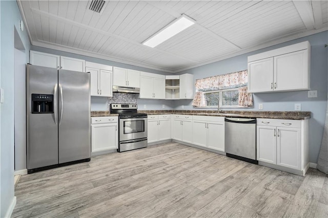 kitchen featuring stainless steel appliances, dark countertops, white cabinetry, and under cabinet range hood