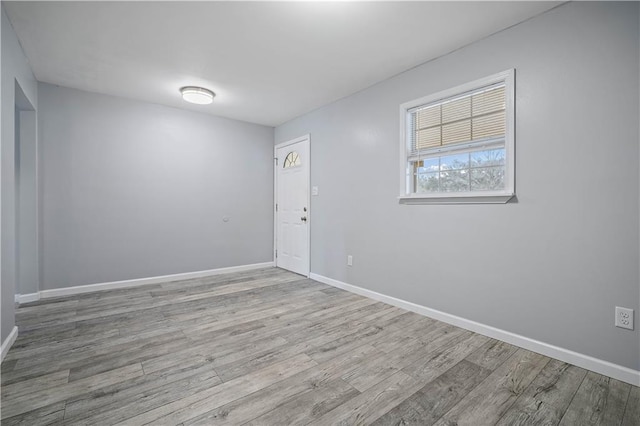 unfurnished room featuring light wood-style flooring and baseboards