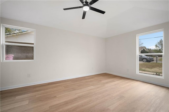 empty room featuring baseboards, light wood-style flooring, and a ceiling fan