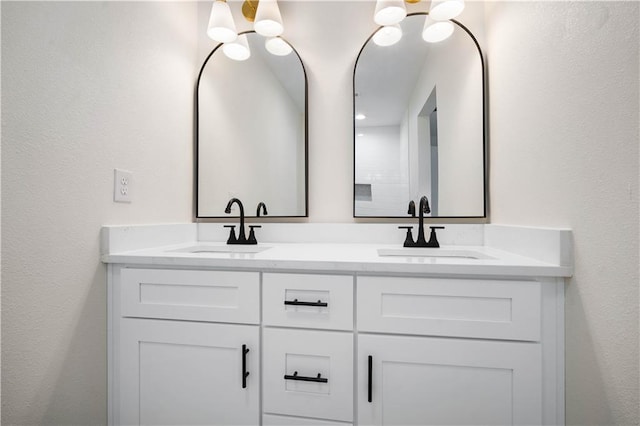 bathroom with a sink and double vanity