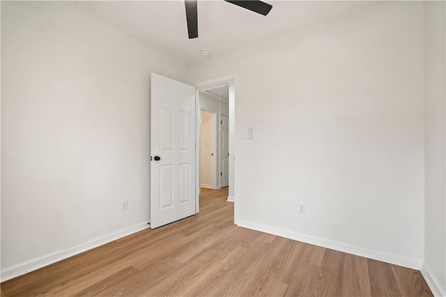 unfurnished room featuring light wood-style flooring, baseboards, and a ceiling fan