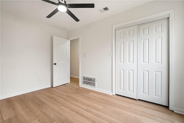 unfurnished bedroom featuring light wood-style floors, visible vents, and baseboards