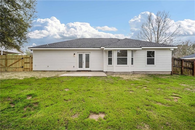 back of house with french doors, a lawn, a fenced backyard, and a patio area