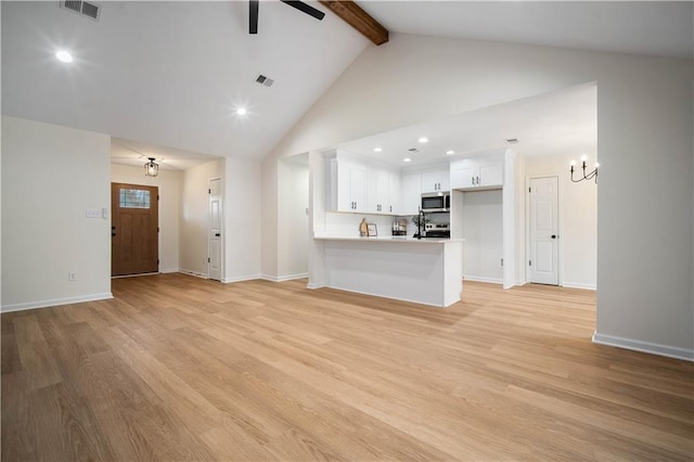 unfurnished living room with beam ceiling, visible vents, light wood-style flooring, and ceiling fan with notable chandelier