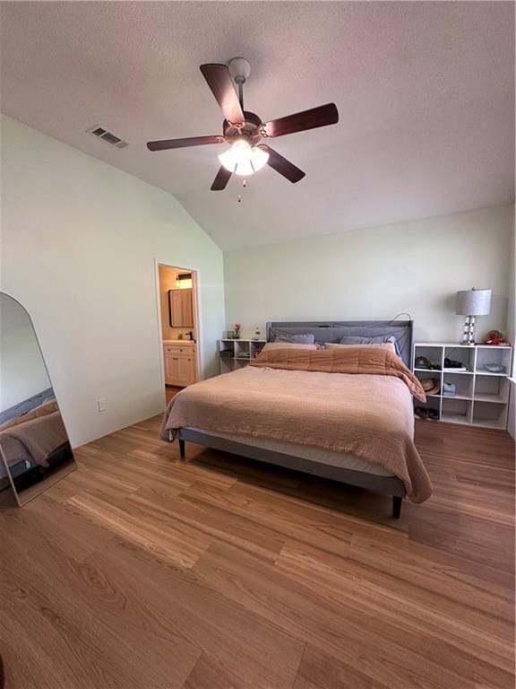 1010 Hamilton Bridges Dr E, Mobile, AL 36695 - bedroom featuring lofted ceiling, wood finished floors, a ceiling fan, and ensuite bath