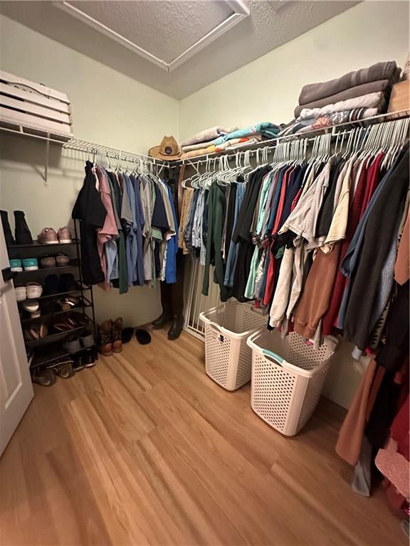 1010 Hamilton Bridges Dr E, Mobile, AL 36695 - spacious closet with wood finished floors and attic access