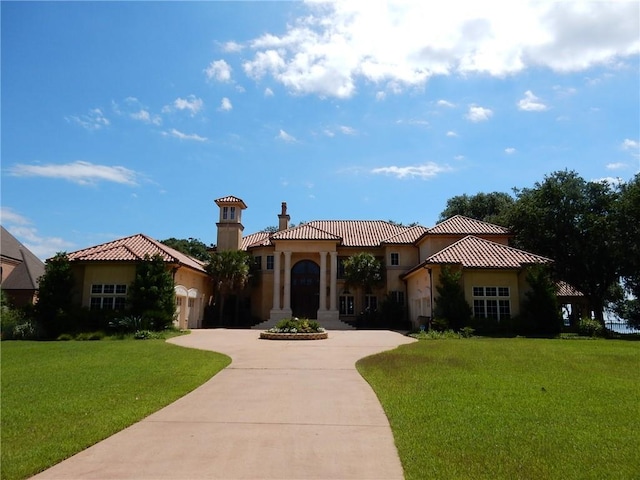 mediterranean / spanish-style home with a front yard