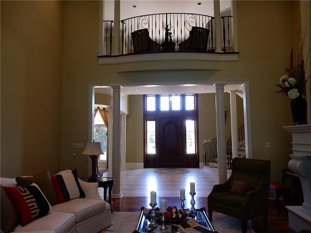 tiled living room with a high ceiling and ornate columns