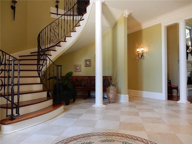 stairs featuring ornamental molding, decorative columns, and light tile floors