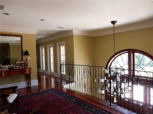 hallway featuring dark wood-type flooring and ornamental molding