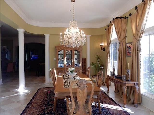 tiled dining room with ornamental molding, a chandelier, and decorative columns