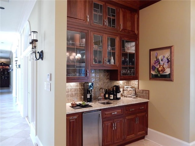 bar with sink, light tile floors, refrigerator, backsplash, and light stone countertops