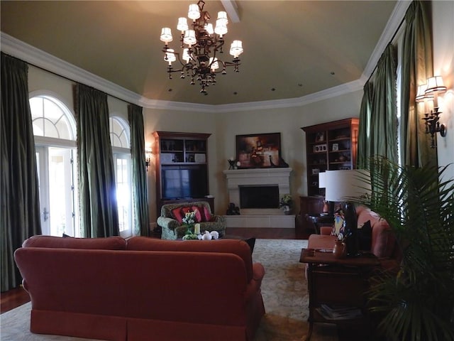 living room featuring a tiled fireplace, crown molding, a notable chandelier, and a wealth of natural light