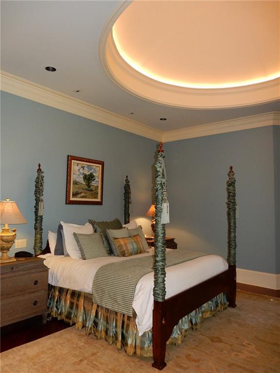 bedroom with ornamental molding and a tray ceiling