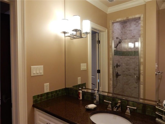 bathroom featuring crown molding, a shower with door, vanity, and a chandelier