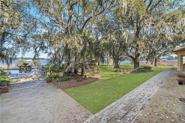 view of nearby features featuring a water view and a lawn