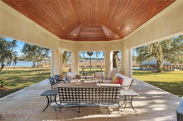 view of patio featuring a water view and outdoor lounge area