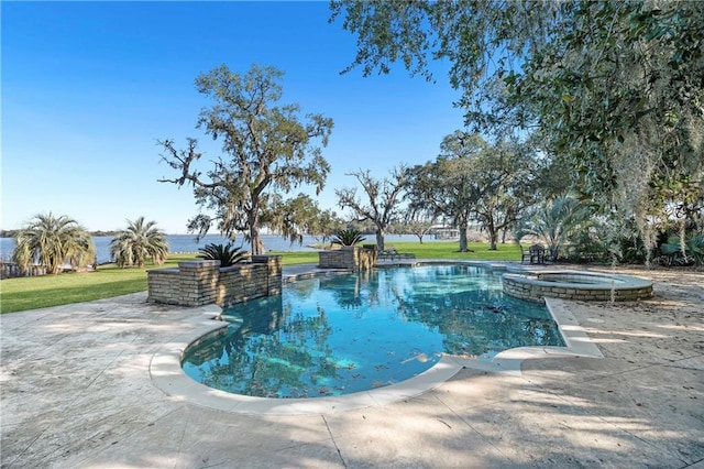 view of swimming pool featuring a patio, a yard, and an in ground hot tub