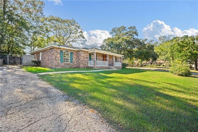 single story home with a front lawn and covered porch