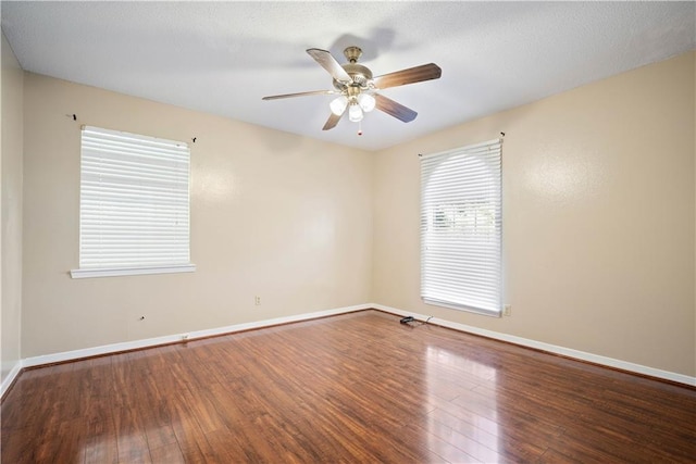 spare room with wood-type flooring and ceiling fan