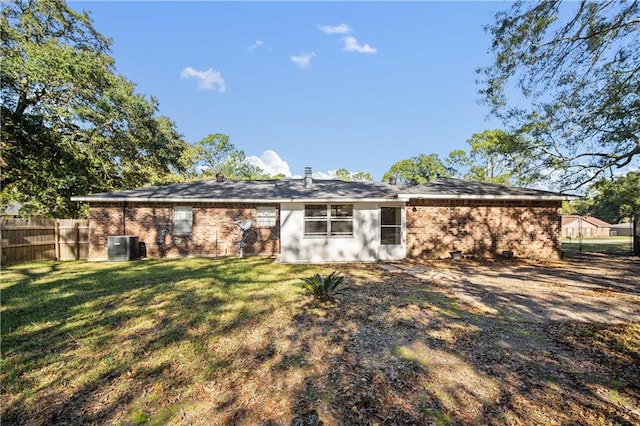 back of house with a lawn and central AC