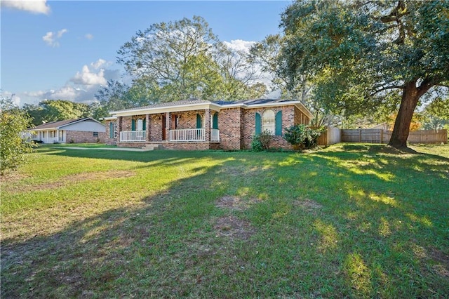 ranch-style home featuring a porch and a front yard