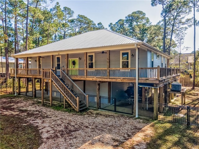 rear view of house featuring covered porch, cooling unit, and ceiling fan