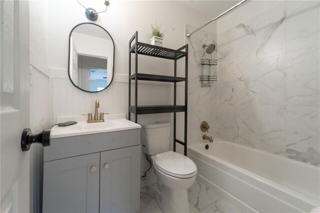bathroom featuring shower / bathing tub combination, toilet, marble finish floor, and vanity