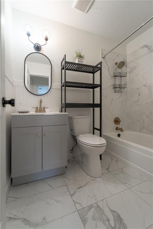 bathroom with visible vents, toilet, shower / bath combination, wainscoting, and marble finish floor