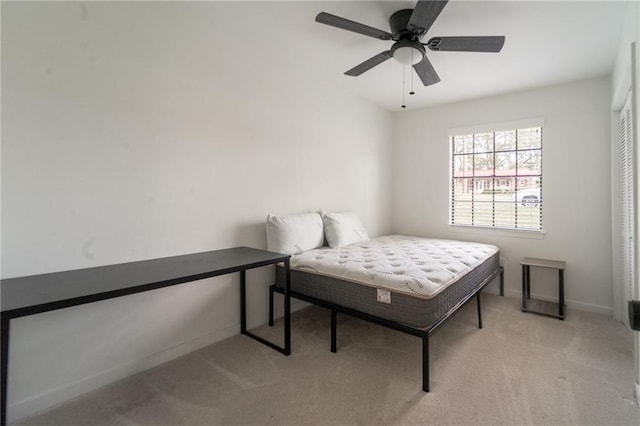 bedroom featuring a ceiling fan, carpet, and baseboards