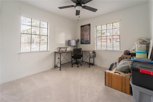 home office featuring baseboards, a ceiling fan, and carpet flooring
