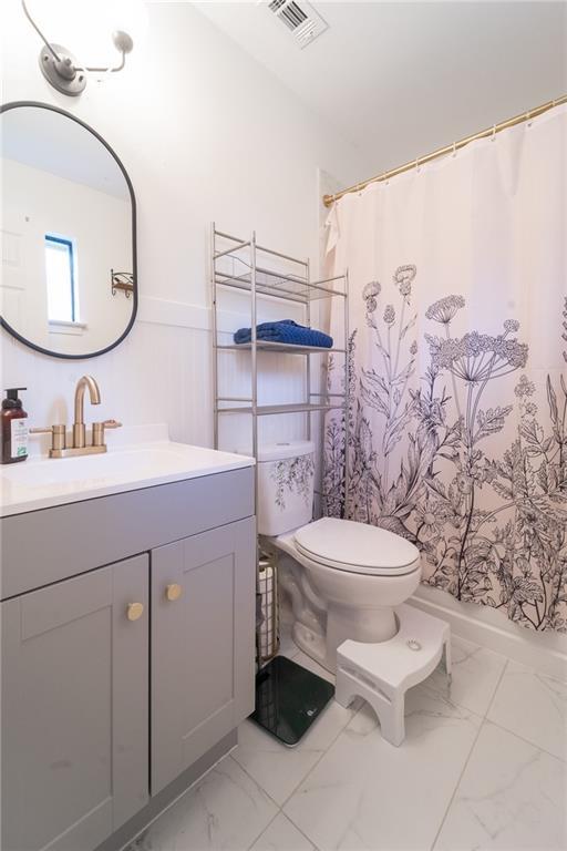 full bath with vanity, a shower with curtain, visible vents, toilet, and marble finish floor