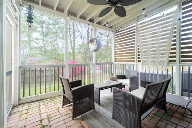 sunroom with outdoor lounge area, a ceiling fan, and a healthy amount of sunlight