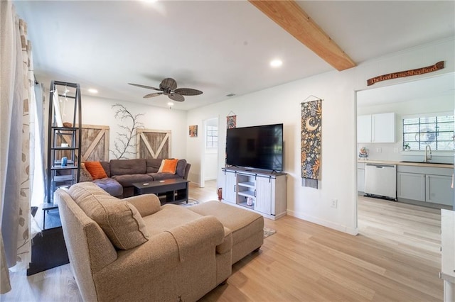 living room featuring baseboards, ceiling fan, light wood-type flooring, beam ceiling, and recessed lighting