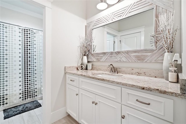 bathroom with hardwood / wood-style floors, vanity, and walk in shower