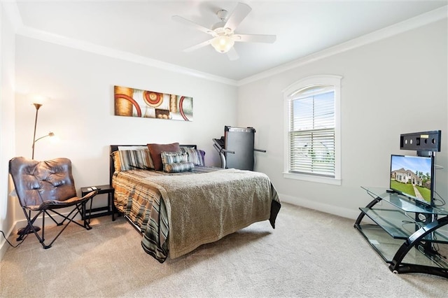 carpeted bedroom with ceiling fan and ornamental molding