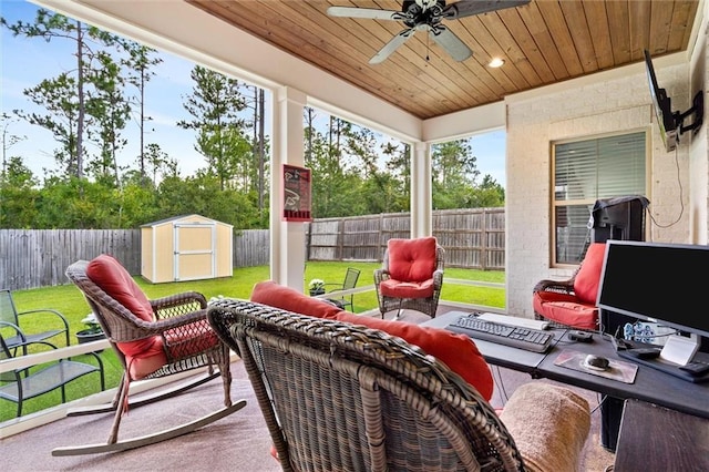 sunroom / solarium featuring ceiling fan and wood ceiling