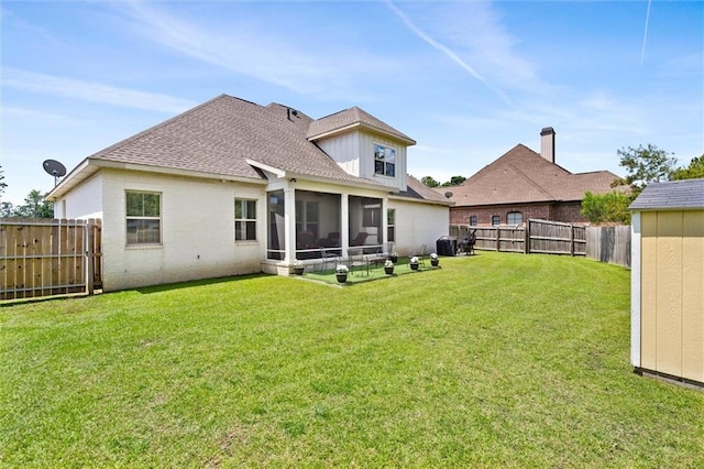 rear view of house with a sunroom and a yard