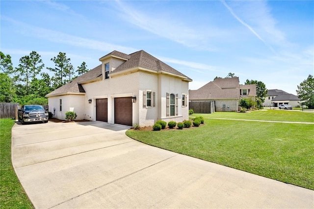 view of front of house featuring a garage and a front lawn