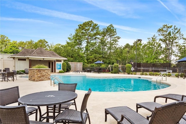 view of swimming pool with an outbuilding and a patio