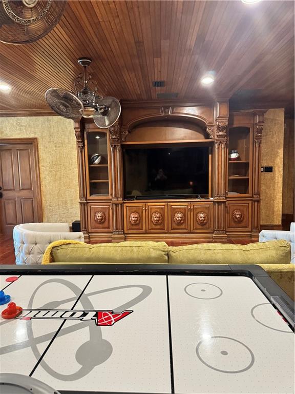 interior space featuring ceiling fan and wooden ceiling